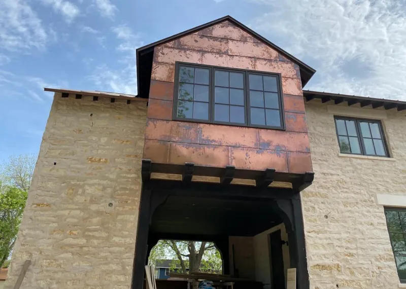 Copper metal panel facade on a stone building for Skylight Installation in Johnson City